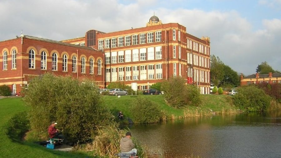 Photo "Coppull Enterprise Centre. With coarse fishing on the former mill lodge, and providing accommodation for a variety of small businesses, this fine former cotton mill on the outskirts of Chorley earns its Enterprising label." by David Hignett (Creative Commons Attribution-Share Alike 2.0) / Cropped from original