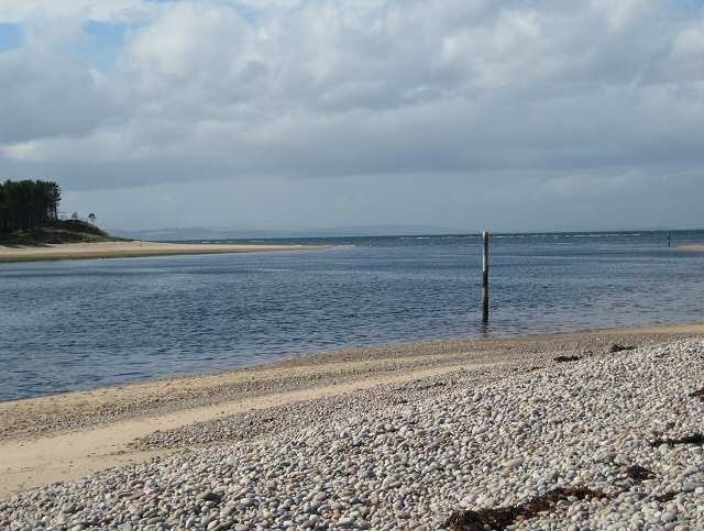 Findhorn estuary The river Findhorn flows into the Moray Firth between the trees of Culbin Forest and the village of Findhorn with its sandy beaches and small harbour.