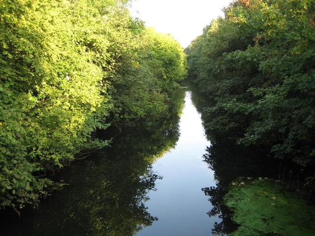 Maidenhead Flood Relief Channel between Bray and Bray Wick Made virtually redundant now by the construction of the Jubilee River, this is the downstream end of the channel shortly before its confluence with The Cut. Photographed here looking upstream and back towards Maidenhead from the Causeway footbridge it is now a quiet backwater. The channel itself was built by the then responsible body, the Thames Conservancy, after the damaging floods of 1947 were followed by further localized flooding in Maidenhead in 1954.