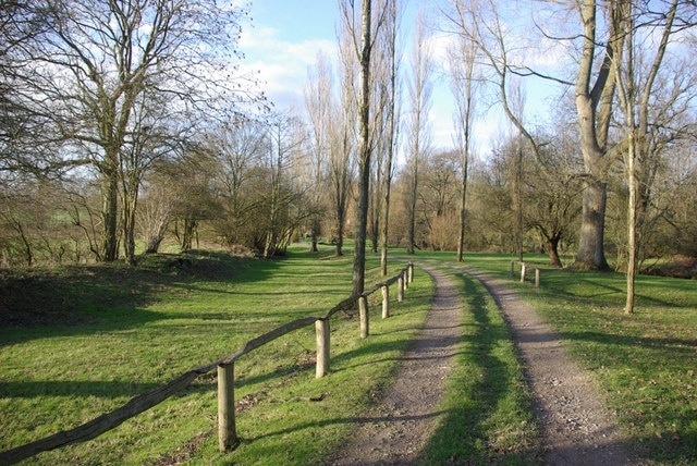 Drive to Lower Parrock and Old Pond Bay In the Medway valley floor, which is quite wide here. Consequently the pond bay (dam) for the old ironworks here was very long and needed to be of little height. The remains are on the left paralleling the drive.