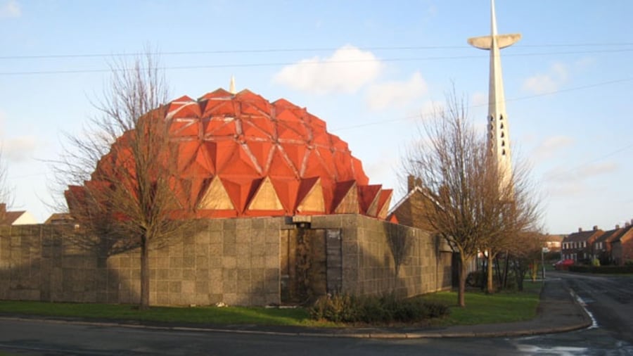 Photo "Church of Christ the King, Bowburn. Oliver Dixon writes at Geograph: "Built in 1976, this striking futuristic church stood in the former mining village of Bowburn. Unfortunately, it suffered serious design faults and was closed in September 2004. At the time of photography the building was in a sorry state with the roof in a poor state of repair, and the whole premises fortified like Fort Knox against vandals. The building was demolished in May 2007, just leaving the cross standing." Update taken from the website www.christthekingchurch.co.uk The Church of Christ the King is the Parish Church (C of E) serving the three villages of Bowburn, Cassop and Quarrington Hill with members of the congregation drawn from all three villages and beyond. A new multi purpose church building and hall was dedicated, after enormous efforts from the congregation, in September 2008, on the site of the old building (once famous in the area as 'the pineapple church'). Worship is in the Catholic tradition of the Church of England within which all are welcome and made to feel at home. The Bishop of Beverley (the Provincial Episcopal Visitor for the Northern Province), the Rt. Revd. Glyn Webster has pastoral and sacramental care of the parish, which is in the Diocese of Durham. The celebration of the Mass (Eucharist or Holy Communion) is at the centre of the parish's worshipping life both on Sundays and in the week. Morning or Evening Prayer is also said daily (Mondays excepted) by the parish priest with others and all are welcome to join in. During the Sunday Mass a small but active Sunday School meets in the hall. On Thursday evenings our parish branch of the Church Lads and Church Girls Brigade, a uniformed organisation for young people aged 5 and upwards, meets in the Church Hall. There is a very active programme of social and fundraising events: fairs, quizzes, suppers etc., normally once a month at which all are welcome. The church hall is available for hire for one off or regular functions normally at £11 per hour. Bookings for Baptisms, Marriages, Banns etc. can normally be made at church on a FRIDAY 5.30PM-6PM. Full details of weekly services, socials and special events can be found on the weekly news sheet or on the notice board outside church." by Oliver Dixon (Creative Commons Attribution-Share Alike 2.0) / Cropped from original
