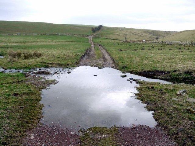 Ford on bridleway south of Alnham The bridleway climbs up ahead over Blackchester Hill. The 1:10000 map indicates that the true source of the River Aln lies up the small valley on the right side of the photo although this has a smaller flow of water than the tributary crossed here.