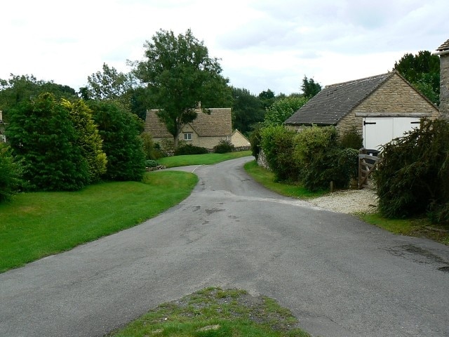 Road junction, Duntisbourne Abbots This is a view to the south-east into the village. The viewpoint is the southern tip of a small triangle of grass between three roads.