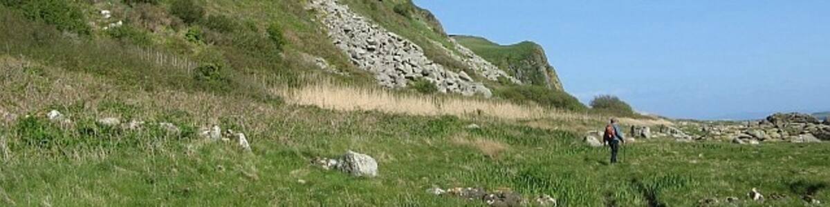 Photo "Arran Coastal Way The southern section of the Arran Coastal Way is fairly ill-defined, but at this point follows a waterlogged track just above the beach." by Eileen Henderson (Creative Commons Attribution-Share Alike 2.0) / Cropped from original