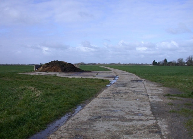 Public Footpath to Barton Presumably also a farm track, or else they have very heavy feet around here. I'm not going to enquire what the heap on the left is!