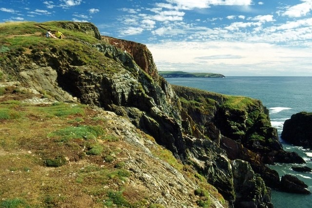 Burgh Island. Showing the rocky seaward side of this small island. The island's owners, who also run the exclusive Burgh Island Hotel and the Pilchard Inn, permit access via a footpath across the summit to this side of the island; relatively few people make it beyond the Pilchard Inn, however! Bolt Tail can be seen in the distance.