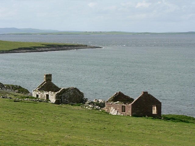 Ruined houses. Beyond is Furs Ness, and in the distance the southern tip of Westray. On the skyline to the left of the picture is Fitty Hill on the west side of Westray.