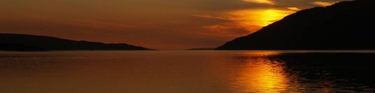 Photo "Sunset from Dundonnell. Looking up Little Loch Broom" by Chris Eilbeck (Creative Commons Attribution-Share Alike 2.0) / Cropped from original