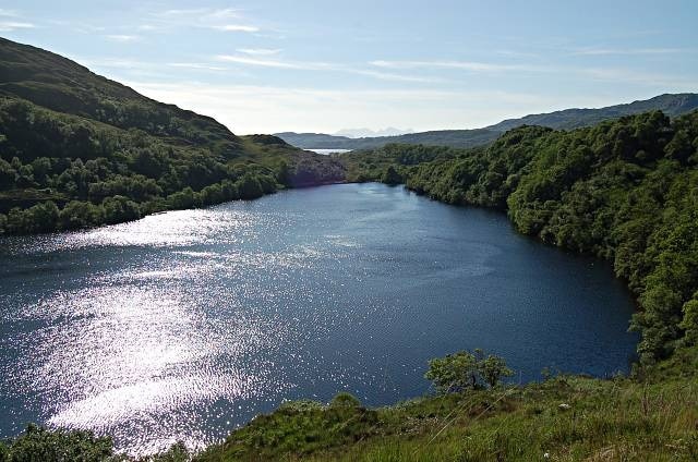 Loch Dubh. With the new road's realignment this fine loch is now almost hidden. Mountains of Rhum in the far distance.