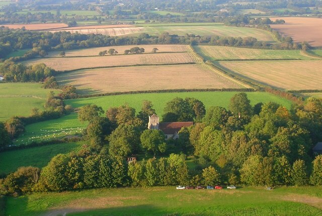 St Andrew's Church Its actually easier to get a shot of the church 500 feet up than from the ground. The church is mainly from the 13th and 14th centuries though it incorporates a wall from an earlier time. The tower was restored in the late 19th century. The foliage hides Edburton House whose chimneys can be seen north east of the church, whilst the chimneys of Michaelmas Cottage are south west of the church. The field below seems to be used as a banger racing circuit judging by the oval shape and the cars parked there.