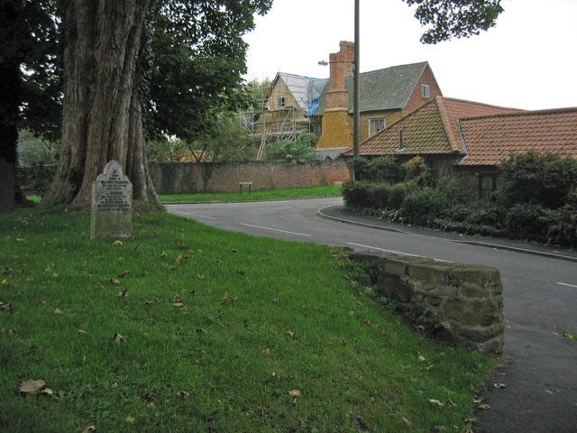 West End, Long Clawson, Leicestershire. The Old Manor House is on West End, opposite St Remegius Church. An Elizabethan & Jacobean Improprietor's House it is believed to be the oldest house in the Vale of Belvoir. It is undergoing much needed restoration. The grave stone in the foreground is for two children who died within days of each other at the turn of the 19th and 20th century. The brother, aged 4, died first and the sister, aged 6, a day later. The gravestone doesn't say what they died of.