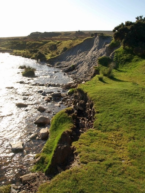 Bank collapse on the Plym The river eats away at the irregular landscape created by china clay working, making a walk along the grassy bank hazardous. It has changed its course here, ironing out meanders and thus becoming swifter; this is probably the reason for the many small weirs that have been built across it in an effort at river-calming.