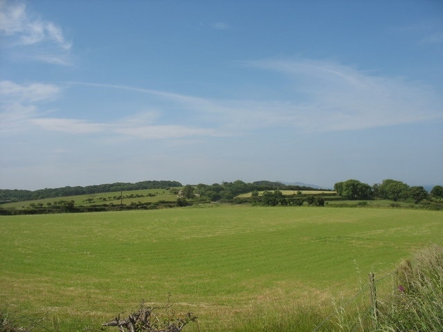 View south-westwards across farmland towards the woodlands of Garreglwyd