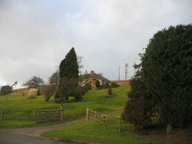 Bordon Hill. Looking up to Bordon Hill from near the entrance to Bordon Hill nurseries on the Evesham Road, with Bordon wood to the right.