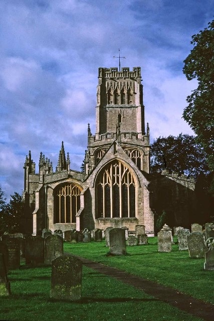 Church of St Peter and St Paul, Northleach, Cotswolds. The Church of St Peter and St Paul in Northleach is known as "The Cathedral of the Cotswolds". The Church as we know it dates from the early 12th century, and was built on top on an even earlier building, also believed to have been a church. The 12th century version of Northleach Church was a fairly simple one, basically consisting of the aisle and not much else. That the chancels were a later addition is immediately apparent from the South Eastern 'quoins' visible in the 'Bicknell' Chapel. Other things changed too, and we know from the scar on the steeply pitched roof of the tower wall that the south aisle was widened twice. The chancel was built in the 1300's, followed by the nave, aisles and sacristy in the 1400's. The overall style of the present church is known as the Late Medieval "Glass Cage" type in which the structure of the church is of less importance than the large, traceried stained-glass windows.