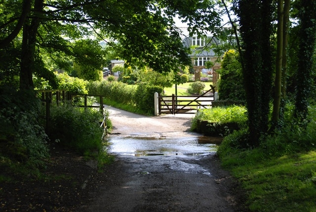 Ford across the stream in Mill Lane, Millthorpe, in the Derbyshire civil parish of Holmesfield. There is a bridge to the left of the photo for pedestrians to cross.