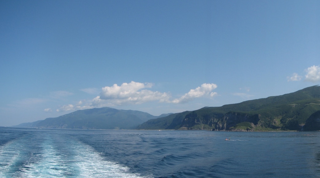 View of Shiretoko National Park. Mount Iō (right) and Mount Shiretoko (far left) seen from Sea of Okhotsk. Six seperate photos wer taken and stiched together with a software.
