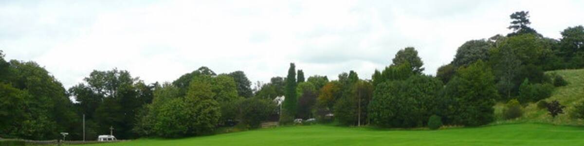Photo "Green space in Almondsbury Land adjacent to the Garden Centre, with Over Lane in the distance." by Jonathan Billinger (Creative Commons Attribution-Share Alike 2.0) / Cropped from original