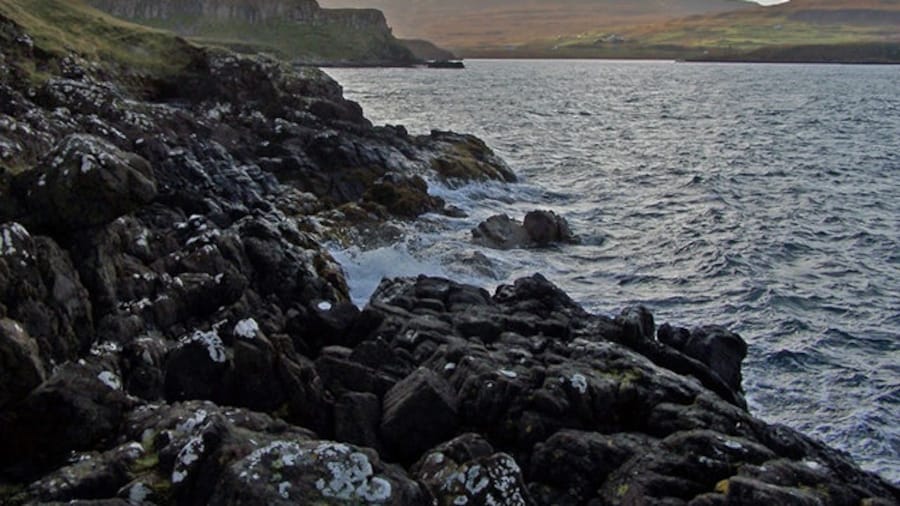 Photo "Rocks at Uiginish Point Looking south west towards Loch Erghallan. The distant mountain is Healabhal Mhòr." by Richard Dorrell (Creative Commons Attribution-Share Alike 2.0) / Cropped from original