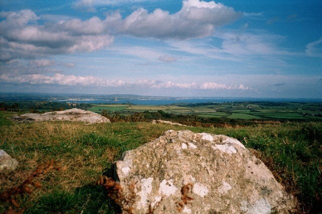 Sancreed Beacon. The stones are cists, Bronze Age burial mounds. This site, which is free to visit and has a small car-park nearby, is maintained by the Cornwall Heritage Trust ( http://www.cornwallheritage.nildram.co.uk/ ). As the background of the picture shows, you can see Mount's Bay (including St Michael's Mount) and the Lizard from the summit.