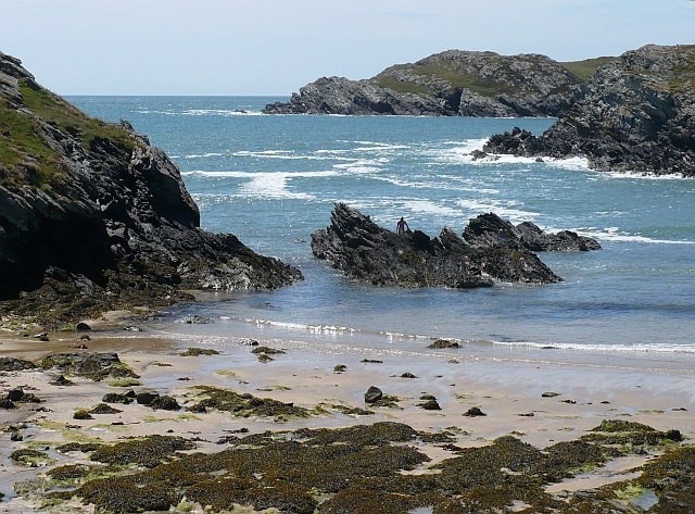 Porth Dafarch Ogof Iron is in the centre in the distance.