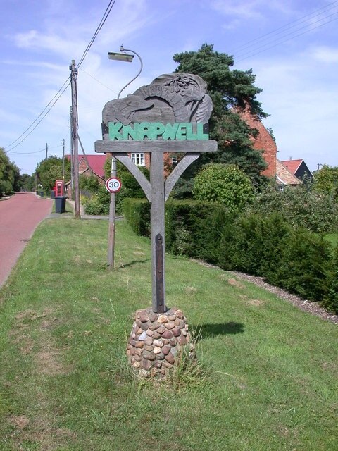 Knapwell Village Sign The carved wooden sign shows a well head, badgers, oxlips and the date 1895, whose significance eludes me.