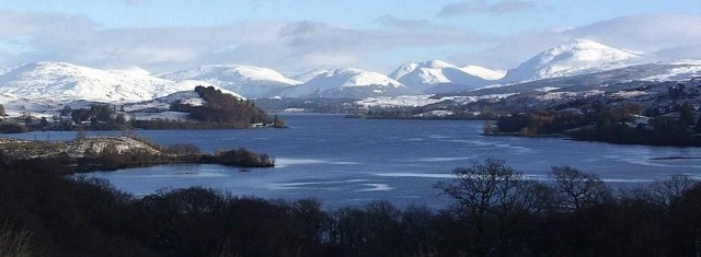 Taychreggan Inn Hotel against the mountains. This is a lovely view up Loch Awe looking towards Kilchrenan from just North of Inverinan. Ben Lui NN2626 and the hills of Glen Orchy in the distance.