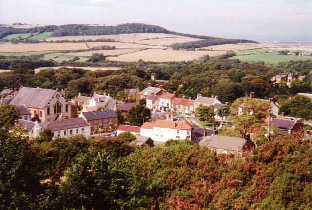 Looking down on Skelton Just before the Cleveland Way drops steeply into Skelton, one gets a birds eye view of the town, with an impressive chapel on the left and Skelton Castle on the right.