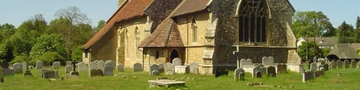 Photo "Brantham St Michael's church, near to Brantham, Suffolk, Great Britain. The moment you approach Brantham church you are struck by the lychgate with its shingled roof and carved roses. The church itself is 14th c. but has been much restored and added to, giving it an especial charm. The church has an original John Constable painting, painted in his early years and presented to the church as an altarpiece in 1804." by Adrian S Pye (Creative Commons Attribution-Share Alike 2.0) / Cropped from original