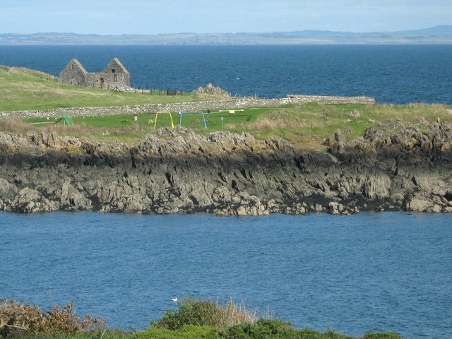 Across the bay This view of Isle Head is taken from across the bay, on the track to Morrach. The remains of St Ninian's Chapel can be seen on the headland.