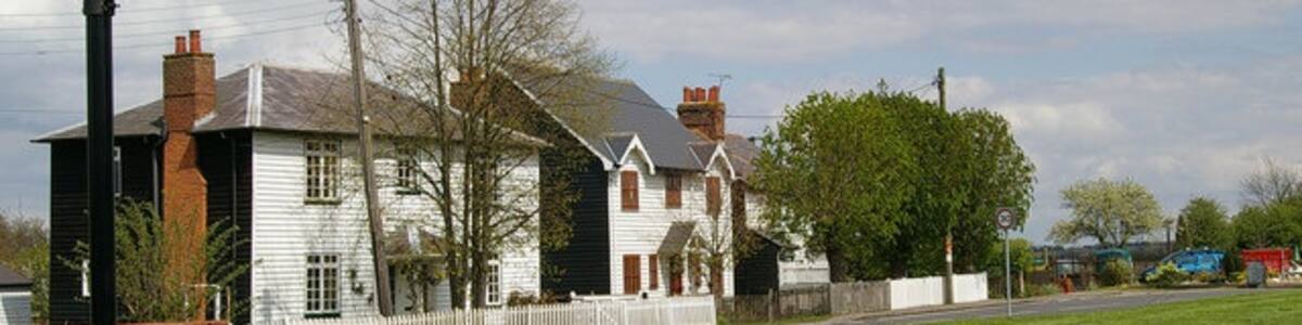 Photo "The Limes and Althorne Sign. The three weather boarded Houses all have lime related names the house in the middle appears to be a modern addition in traditional style." by Glyn Baker (Creative Commons Attribution-Share Alike 2.0) / Cropped from original