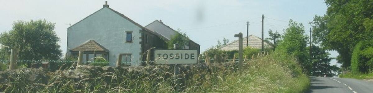 Photo "Tosside, North Yorkshire. The road into this small North Yorkshire village" by Stuart and Fiona Jackson (Creative Commons Attribution-Share Alike 2.0) / Cropped from original