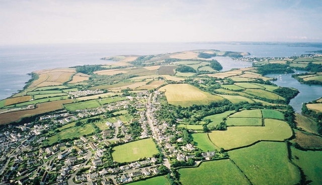 Aerial view from Paramotor of Roseland Peninsula - Portscatho in foreground, St Anthony's Head and Fal Estuary in distance