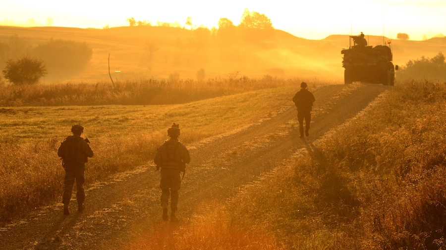Photo "U.S. Army Europe soldiers of the 2nd Cavalry Regiment, patrol a road at the Grafenwoehr Training Area at sunrise during Saber Junction 2012, Oct. 13. U.S. Army Europe's exercise Saber Junction trains U.S. personnel and more than 1,800 multinational partners from 18 European nations ensuring multinational interoperability and an agile, ready coalition force. Training Support Activity Europe Photo by Markus Rauchenberger Date Taken:10.13.2012 Location:GRAFENWOEHR, BY, DE Read more: www.dvidshub.net/image/722455/saber-junction-2012#.UHxHHB..." by DVIDSHUB (Creative Commons Attribution 2.0) / Cropped from original