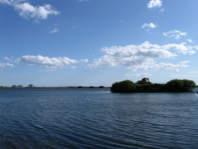 Island in the Gravel Pit Aggregates and ballast were extracted in the 1970s and once the pits were filled in with water they became part of the Dungeness Nature Reserve with islands formed within the pit important for nesting wildlife. Dungeness nuclear power station is in the distance on the left.