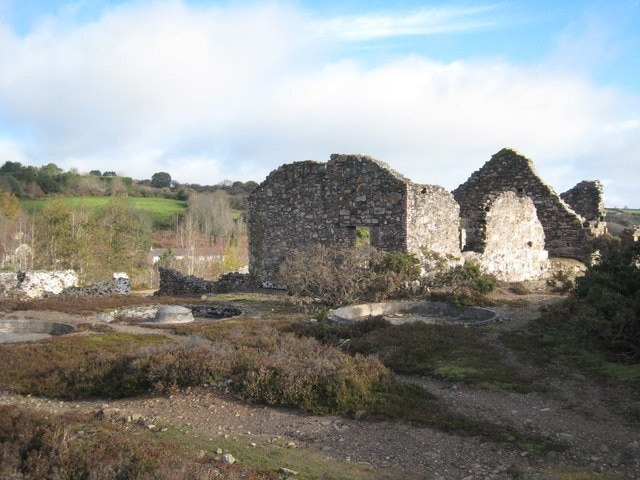 Remains of mine workings at Poldice mine The three circular pits in the foreground are buddles, where the tin particles would have been separated from the slurry.