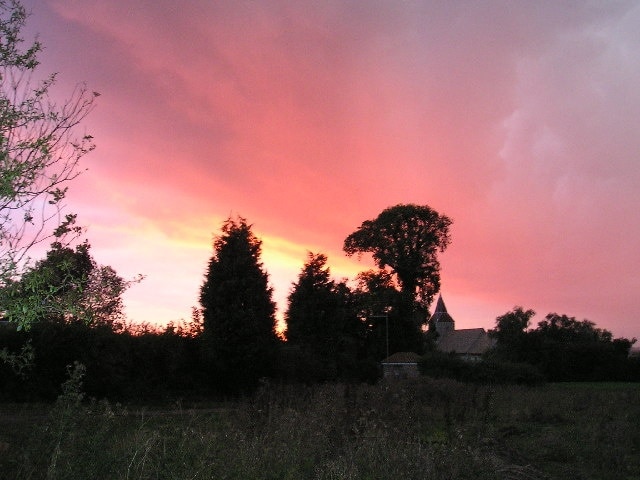 Sunset at Pidley, Cambridgeshire (formerly Huntingdonshire), silhouetting trees and (centre right) All Saints' parish church