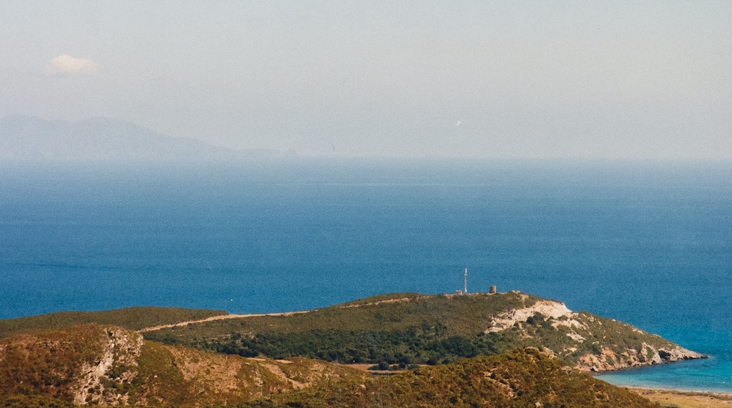 The Coscia cape (Punta di a Coscia) supporting ruins of a windmill, north of Macinaggio, Rogliano, Haute-Corse (Corsica). The Tuscan archipelago can be seen in the distance.