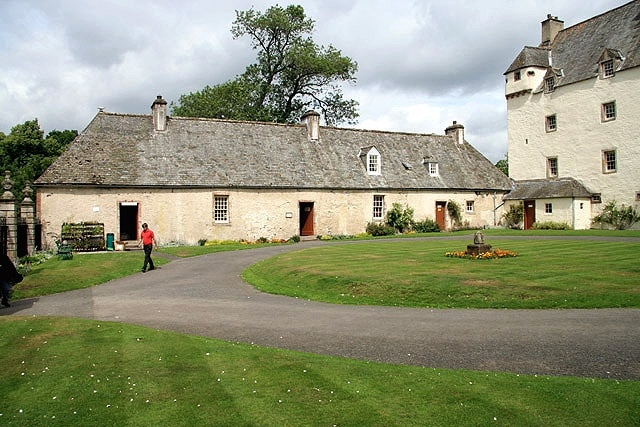 Traquair House A view from the courtyard in front of the main house to the north wing that accommodates from left to right, a gift shop, brewery shop and chapel.