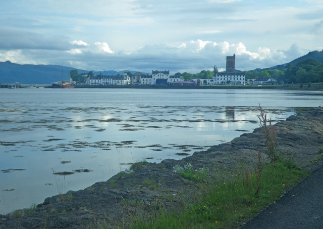 Shoreline and tideland along the A83 Road, near to Ardrishaig, Argyll And Bute, Great Britain. This is an evening view looking south along the shoreline with the town of Ardrishaig in the distance.