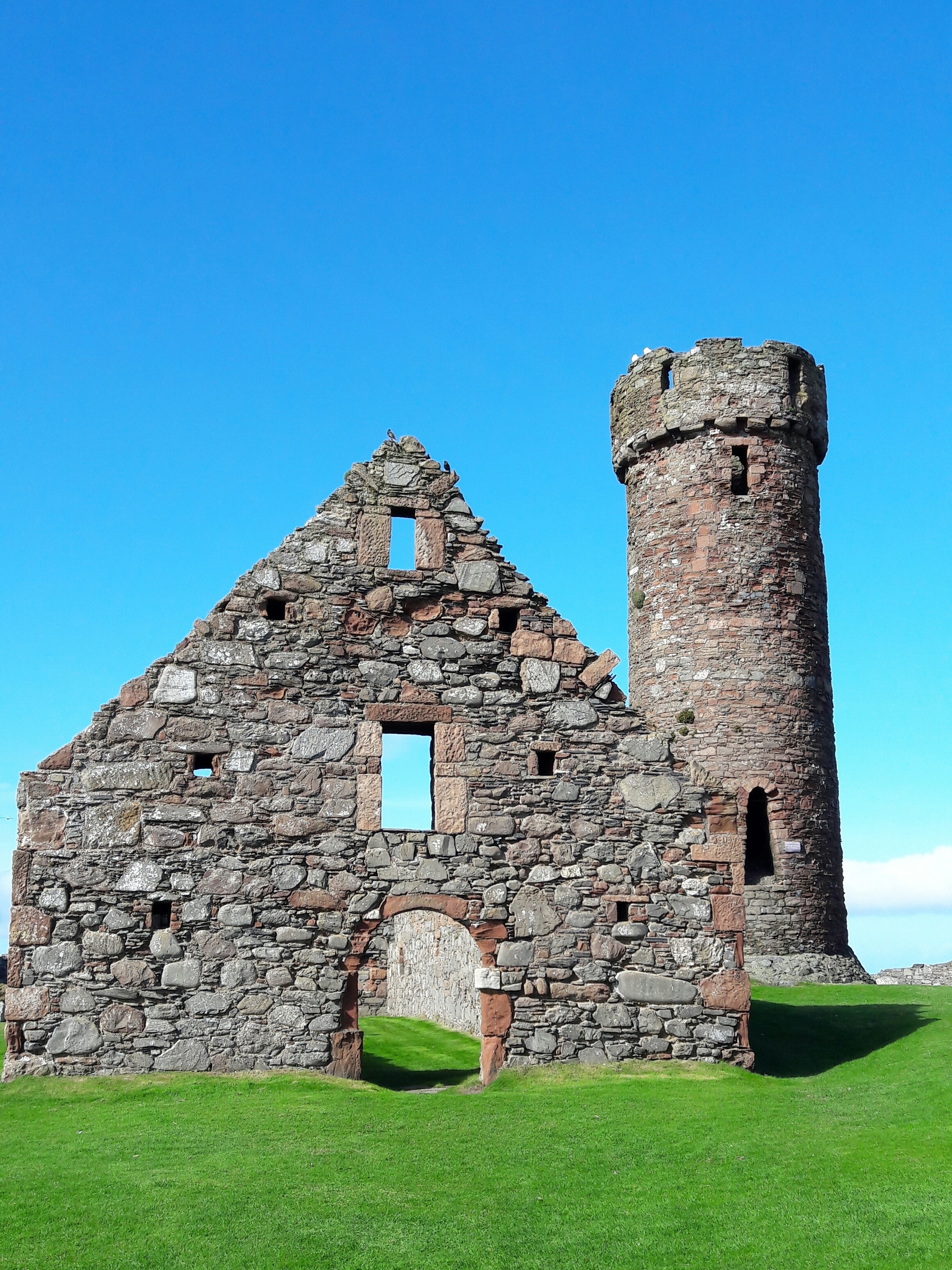 The late 14th century garrison hall and the 10th or 11th century round tower at Peel Castle