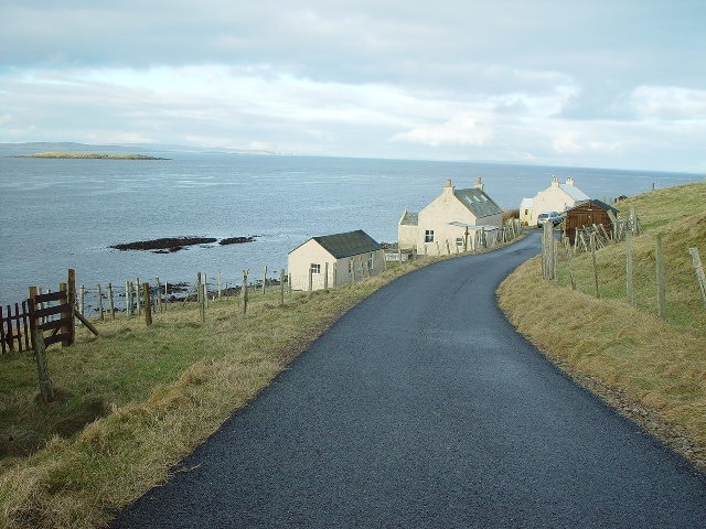 Houses at 'Booth' Marrister, Whalsay, Shetland. Looking north to Booth Skerry and the houses at 'Booth' Marrister, Whalsay. In the background is Wether Holm and on horizon is the south end of island of Yell.