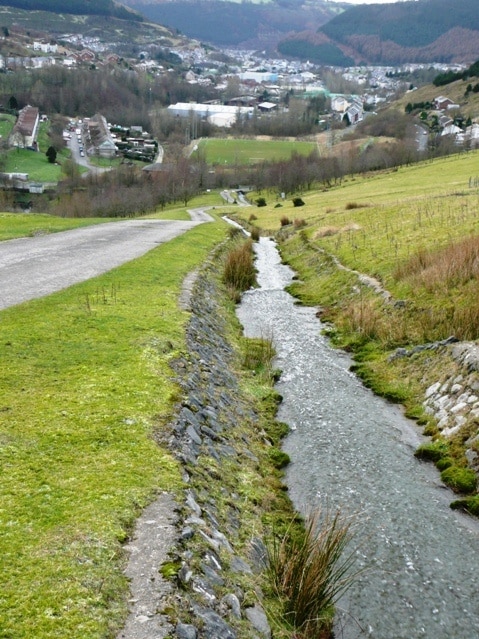 Race you down to Tyleri A leat flowing from disused mines takes water down the hillside towards Cwm Tyleri. The access road is a steep bridleway.