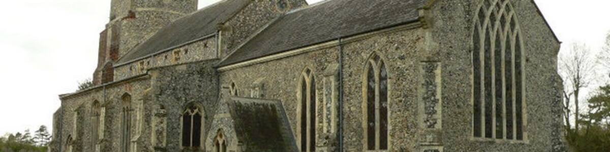 Photo "Denton St Mary Church One of 124 round tower churches in Norfolk. Well, not much of a round tower to see, but the base is indeed round, therefore it counts as one of them." by Bernd Jatzwauk (Creative Commons Attribution-Share Alike 2.0) / Cropped from original
