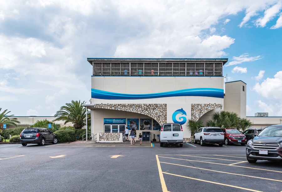 Exterior view of Gulfarium Marine Adventure Park with parking area in Destin, Florida.