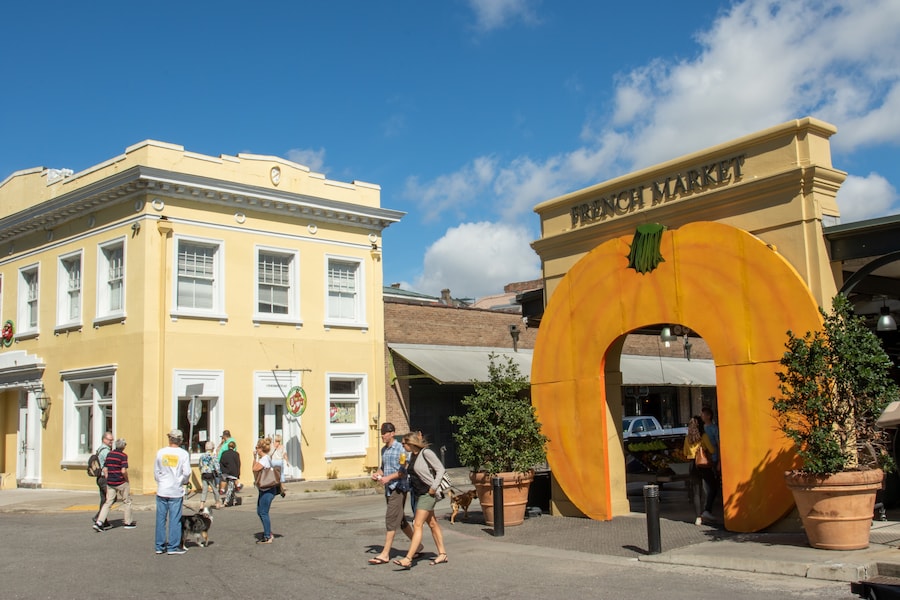 Entrance to the French Market in New Orleans, featuring vibrant colors and lively atmosphere.