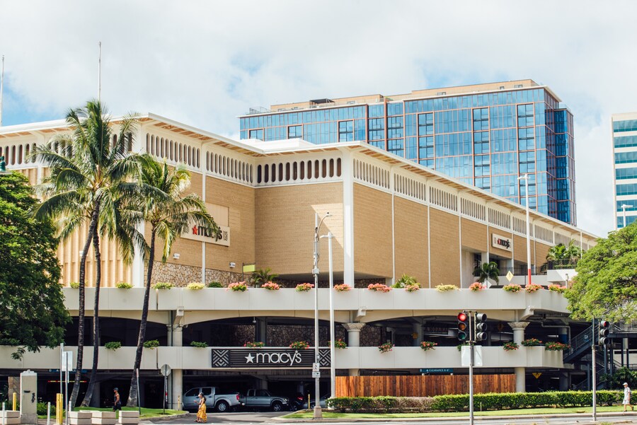 Exterior view of Ala Moana Center in Honolulu, Hawaii, featuring shops and palm trees.