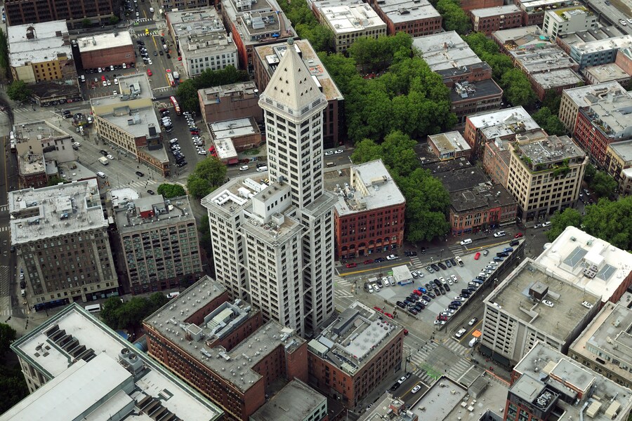 Aerial view of Smith Tower surrounded by downtown Seattle buildings.