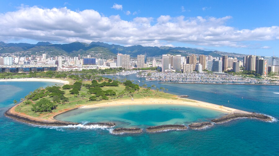 Aerial view of Magic Island in Honolulu with lush greenery and ocean views.