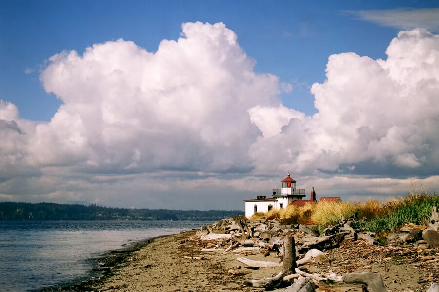Scenic beach view with the historic lighthouse at Discovery Park in Seattle, Washington.